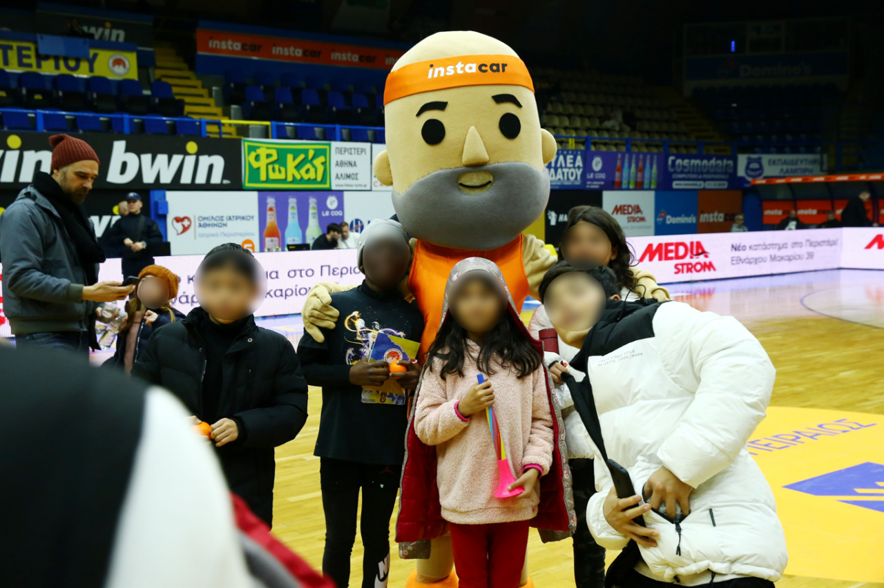 Car Boldie instacar's mascot poses with children from SMAN organization
